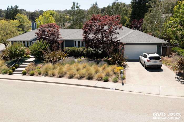Home exterior in San Rafael, featuring James Hardie Evening Blue lap siding and Arctic White trim with landscaped yard