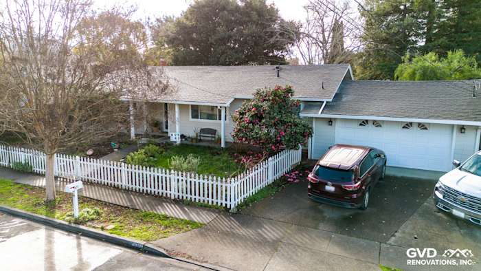 Home exterior transformation featuring new landscaping, white picket fence, and a modern upgrade in Napa, CA