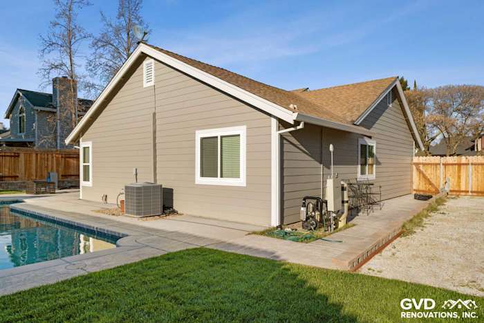 Monterey Taupe HardiePlank siding with Arctic White trim on renovated Folsom home exterior near pool