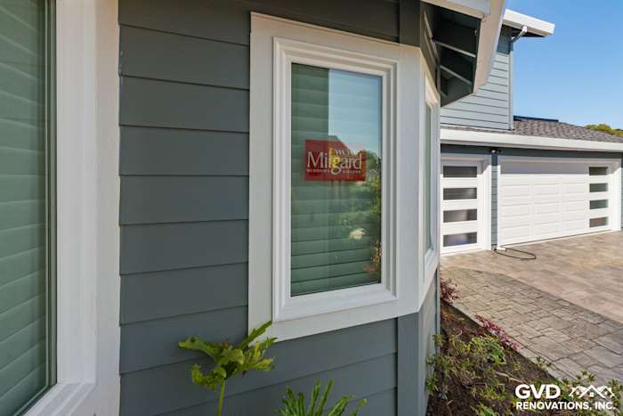 Boothbay Blue HardiePlank siding with Arctic White trim and Milgard window in Foster City home exterior