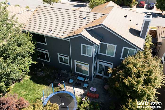 Exterior view of a Petaluma home featuring Night Grey James Hardie siding and Arctic White trim, with vinyl windows
