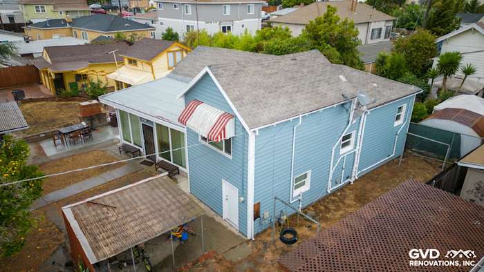New Alside Prodigy vinyl siding in light blue with updated windows on a residential home in Oakland