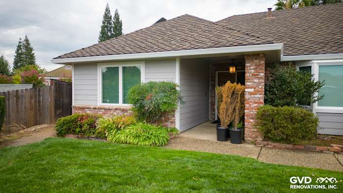 Modern home exterior featuring James Hardie Cedarmill siding, Milgard windows, and lush landscaping in Roseville