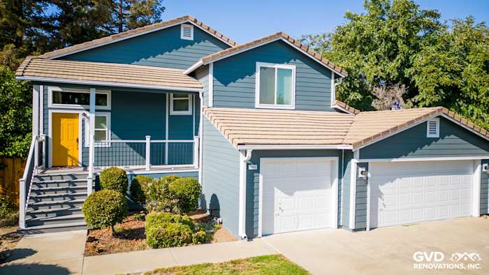 Updated home exterior in Dixon with blue James Hardie siding, new Anlin windows, and fresh deck