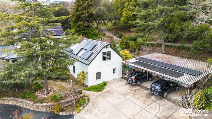 Exterior view of a Sonoma home featuring James Hardie Arctic White siding, Marvin windows, and a carport with solar panels