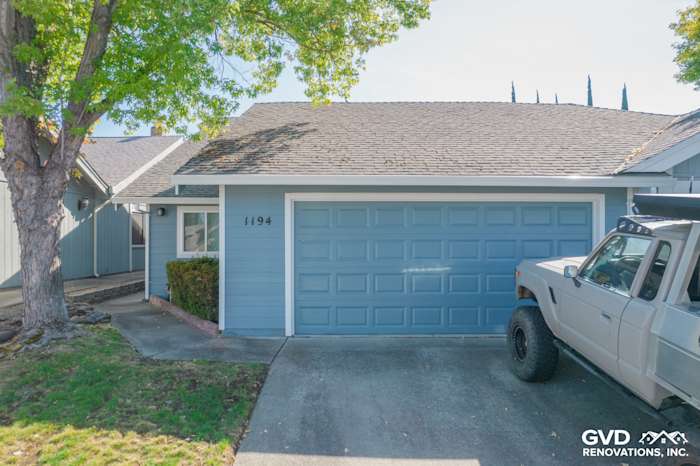 Home exterior in Roseville featuring Boothbay Blue James Hardie siding, Arctic White trim, and a green lawn