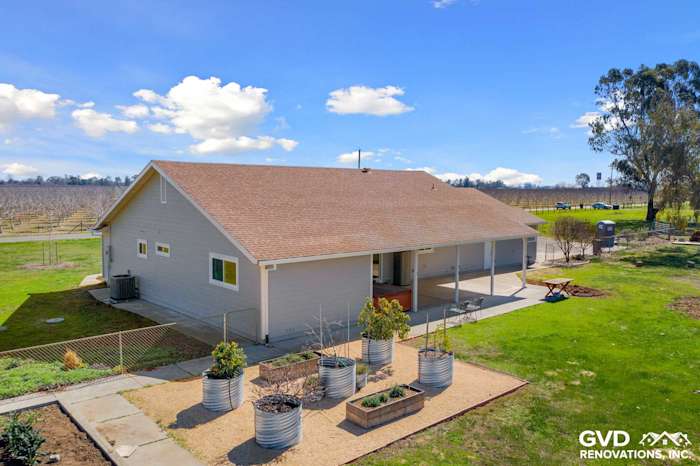 Home exterior showcasing Pearl Gray James Hardie Siding, Arctic White trim, and landscaped garden beds in Galt, CA