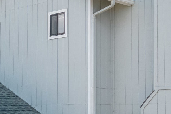 Newly installed light gray siding and Milgard Trinsic windows on a modern home exterior in El Sobrante