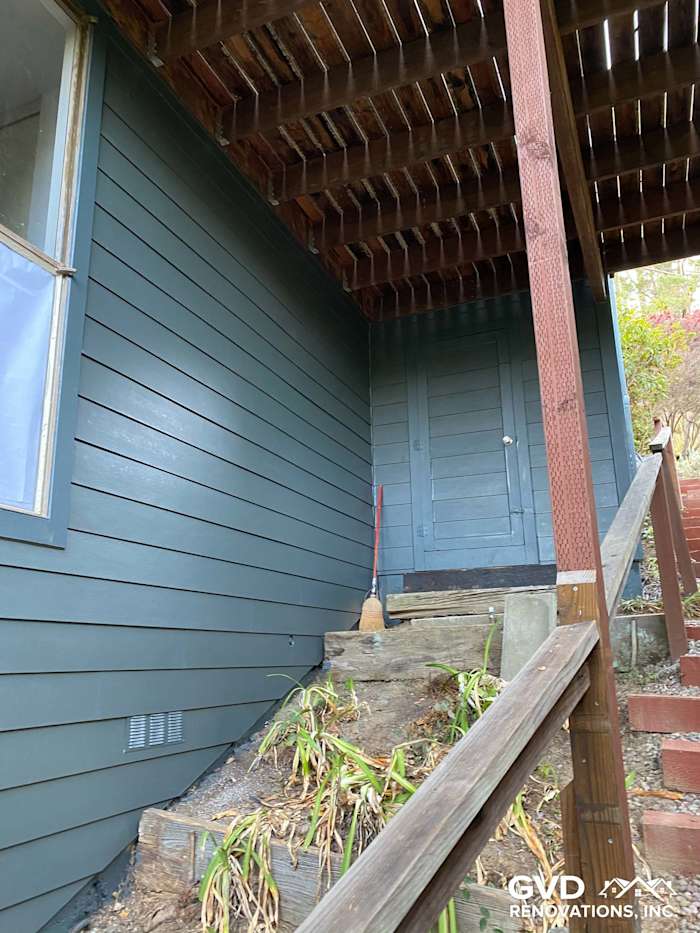 James Hardie siding in dark blue on a Mill Valley home with staircase and deck overhead