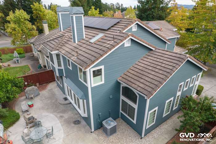 Home exterior showcasing James Hardie Evening Blue Lap Siding with a modern roof and solar panels in Petaluma