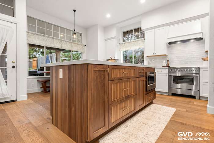 Modern kitchen remodel featuring Waypoint cabinets, Fieldstone island, and mitered Vadara Bronzo countertops