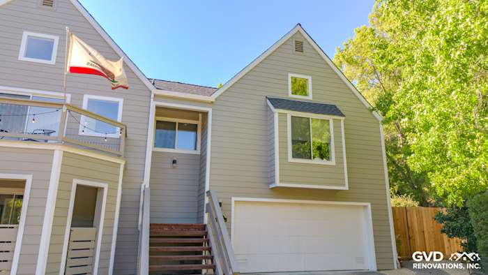 Two-story home exterior with James Hardie Monterey Taupe siding, Arctic White trim, and wooden steps in San Rafael