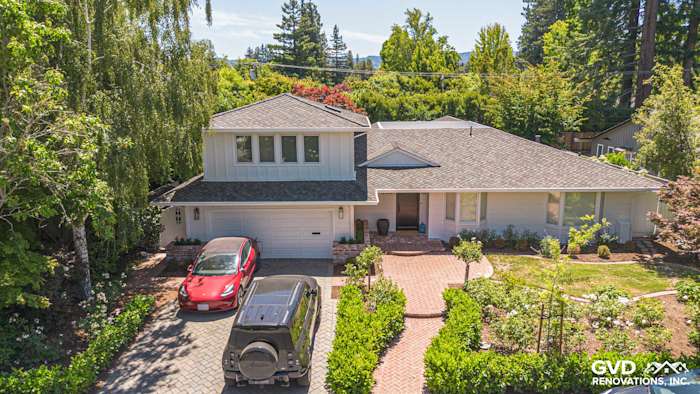 Menlo Park home exterior showcasing James Hardie Batten Board & Artisan Siding with stylish landscaping and brick pathway