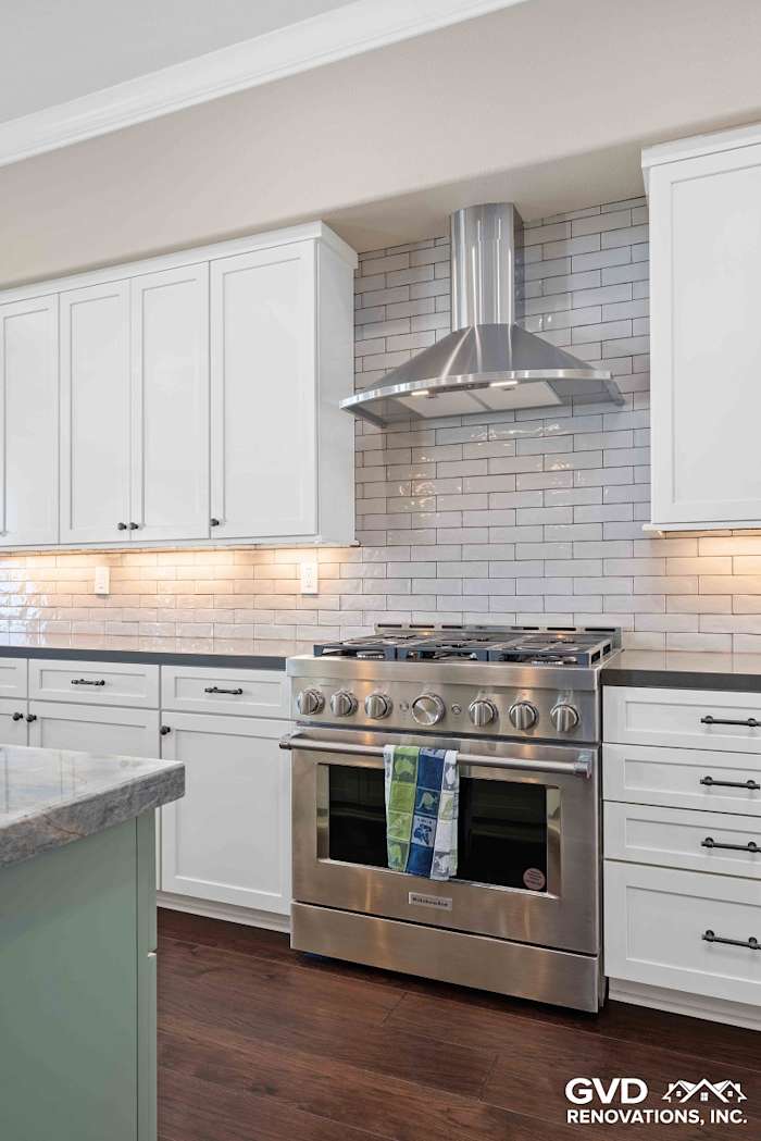 Modern kitchen with stainless steel range, white cabinetry, and subway tile backsplash in El Dorado Hills