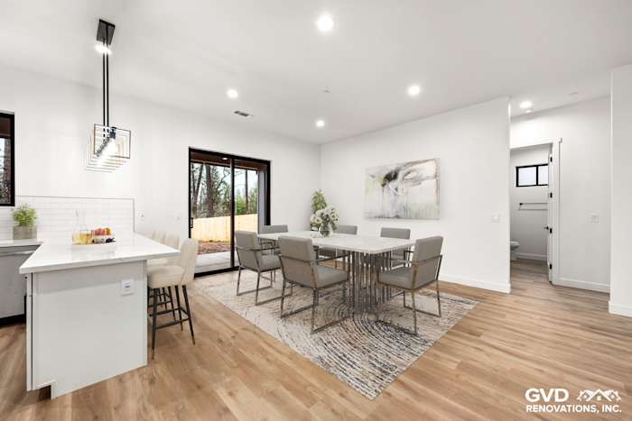 Modern kitchen in Paradise, CA with Waypoint cabinetry, dining area, and sleek fixtures