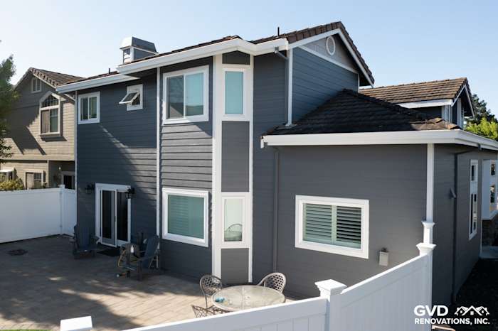 Exterior view of a home featuring James Hardie Night Gray lap siding, Pearl Gray shingle siding, and Arctic White trim