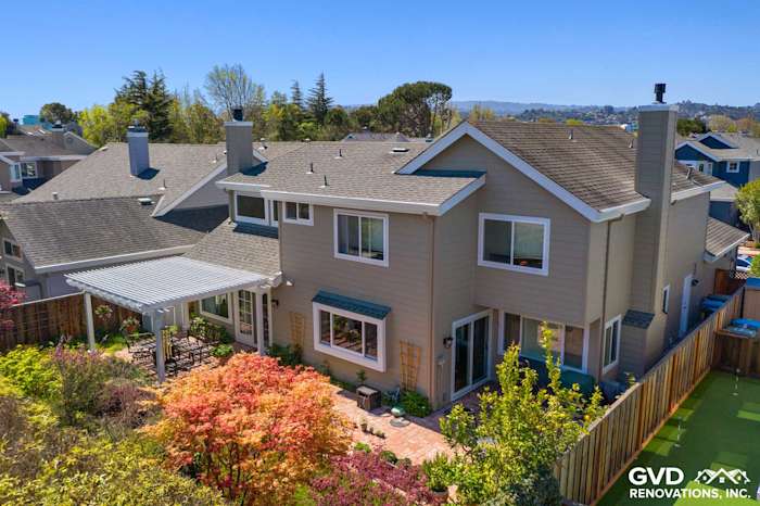 Two-story home exterior in Foster City with Monterey Taupe James Hardie siding and Arctic White trim, featuring Mezzo windows