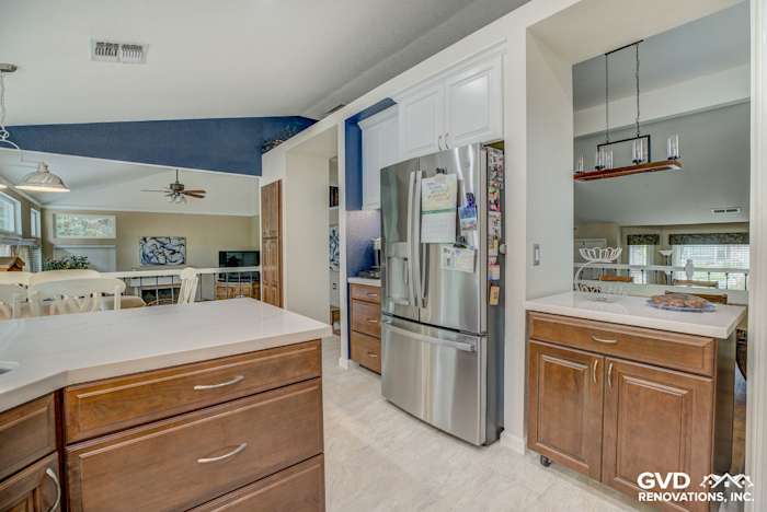 Modern kitchen remodel featuring stainless steel appliances, quartz countertops, and dark wood cabinetry in Elk Grove