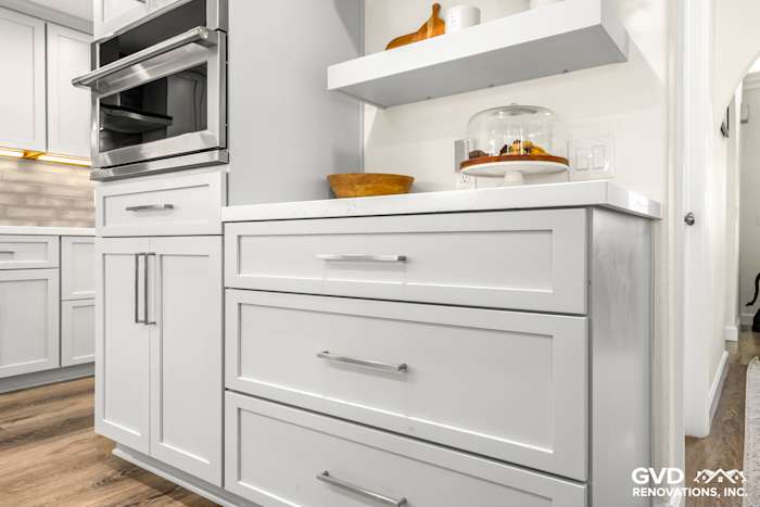 Modern kitchen remodel with sleek white cabinetry, quartz countertop, and built-in oven in Rocklin, CA