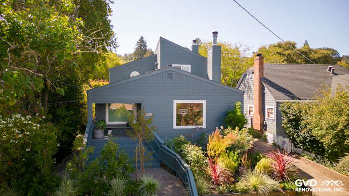 Corte Madera home with James Hardie Evening Blue siding and Arctic White trim, featuring lush landscaping