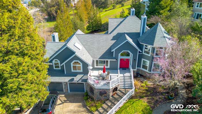 Home exterior featuring Night Gray James Hardie siding and Arctic White trim in Petaluma, CA, with a red front door