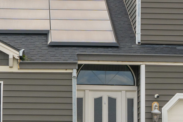 Modern home exterior in Stockton featuring Prodigy Siding in gray, solar panels, and landscaped front yard