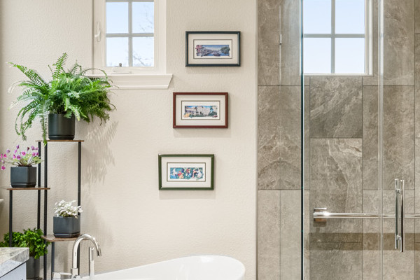 Modern master bathroom with granite countertops, a freestanding tub, and a walk-in glass shower in Roseville