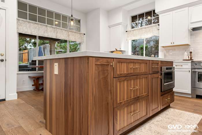 Sleek kitchen island with walnut cabinetry, Custom Vadara Bronzo countertop, and modern hardware in Folsom remodel