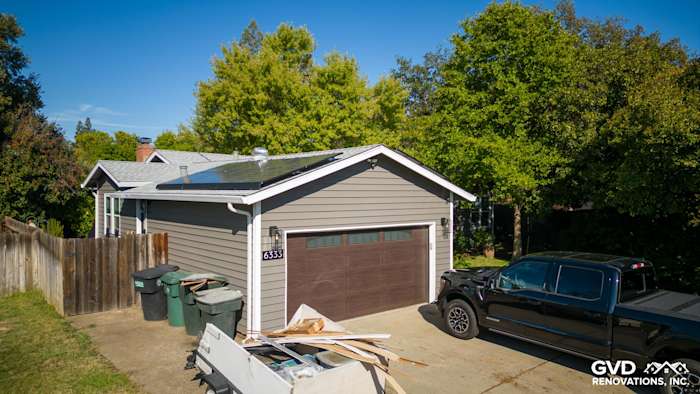 Newly installed Alside Prodigy Vinyl Siding in gray on a Carmichael home, featuring Milgard windows and a double garage