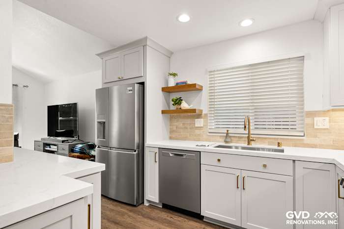 Modern kitchen with Waypoint cabinetry, Vadara Naurelle stone countertops, and MSI Brickstone Ivory backsplash in Roseville