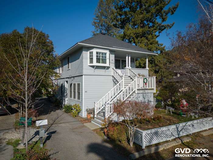 Modern home exterior showcasing Prime James Hardie Lap Siding in Arctic White, complemented by a stylish staircase