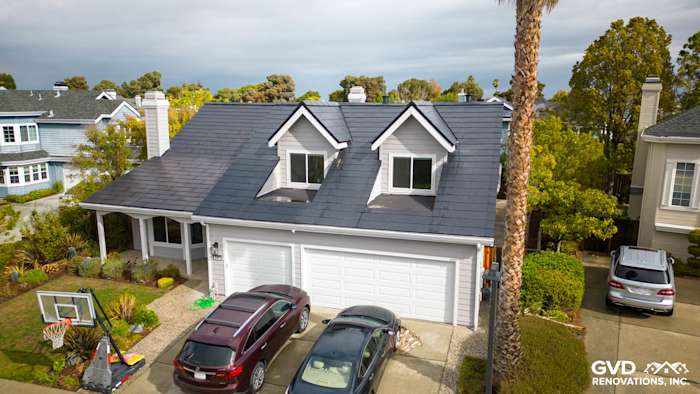 Home exterior in Foster City with new Pearl Gray James Hardie siding and Arctic White trim, featuring a modern roof