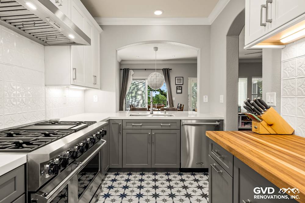 Modern kitchen featuring gray cabinetry, white subway tile backsplash, and a unique star-patterned floor in Folsom, CA