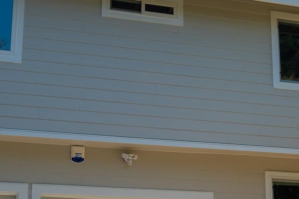 Home exterior featuring James Hardie lap siding in Cobble Stone with Arctic White trim and new windows in Novato, CA
