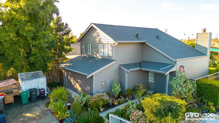 Home exterior featuring newly installed Ageless Slate Alside Prodigy Vinyl siding in Hayward, CA, surrounded by lush