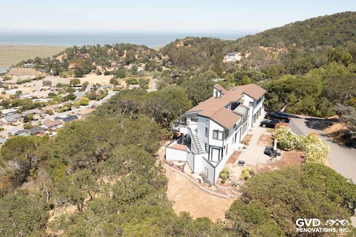Aerial view of a home in San Rafael, CA with new Arctic White James Hardie siding and surrounding greenery