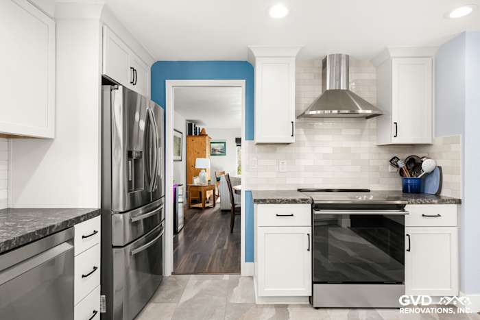 Modern Fair Oaks kitchen featuring stainless steel appliances, white cabinets, and blue accent wall