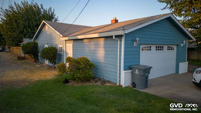 New Alside Prodigy vinyl siding in light blue on a Yuba City home exterior with landscaping and garage