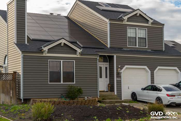 Modern home exterior featuring Prodigy Siding in gray with solar panels, landscaping, and a two-car garage in Stockton, CA
