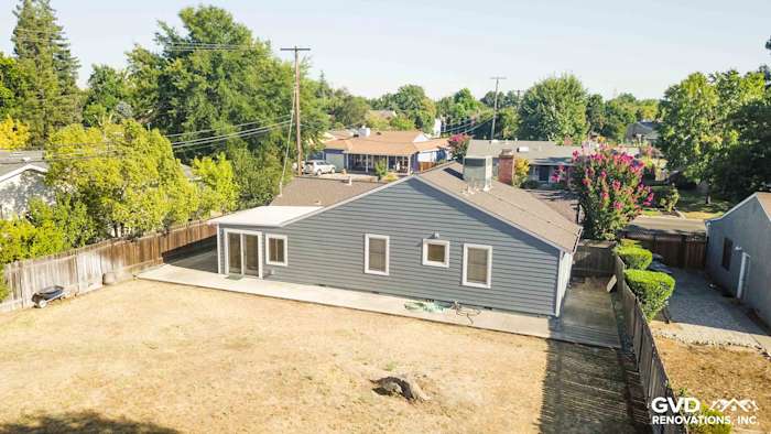 Home exterior featuring Boothbay Blue James Hardie siding, Arctic White trim, and a spacious backyard in Sacramento