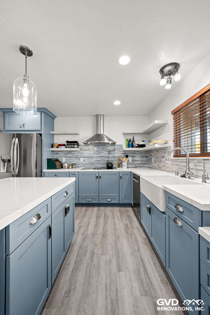 Modern kitchen remodel in Elk Grove with blue Waypoint cabinets, white MSI Calacatta Ultra countertops, and Misty Fjord