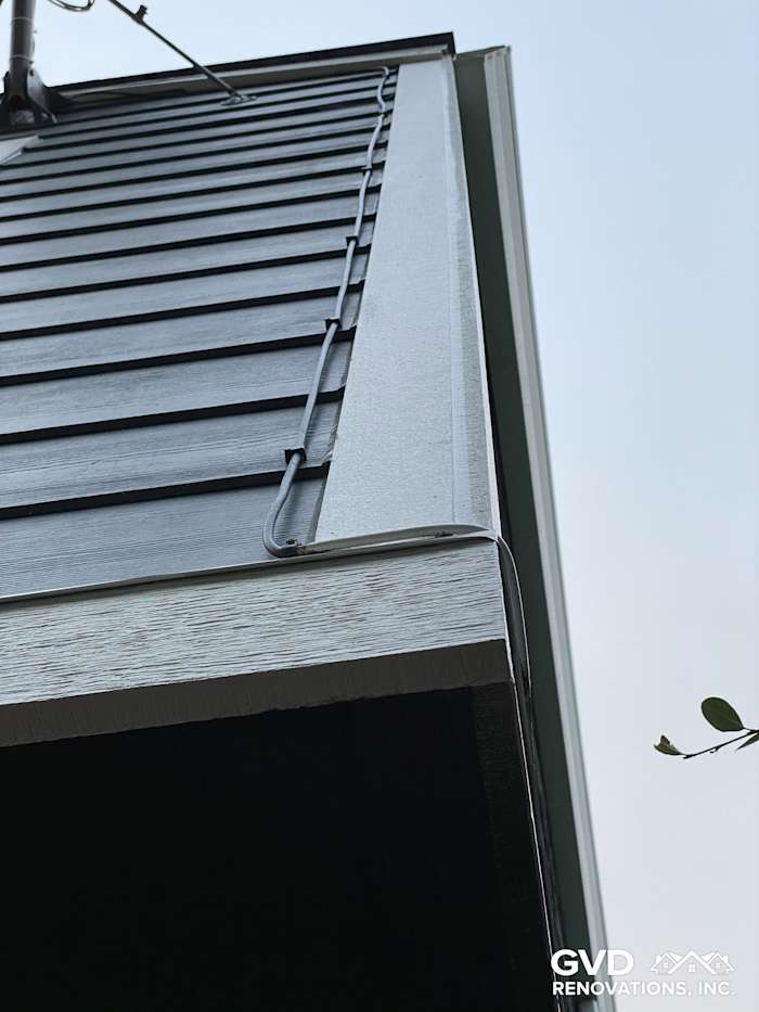 Close-up of new James Hardie siding with vertical planks and trim, showcasing a sleek finish