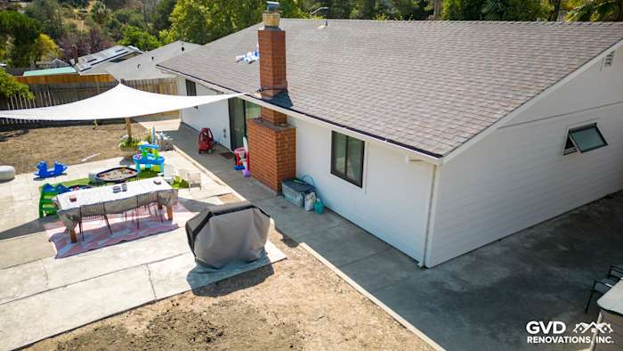 Back view of home featuring Arctic White James Hardie siding, outdoor patio area, and shading structure in Pinole, CA