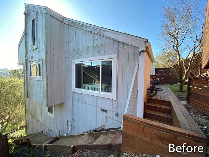 Mill Valley home exterior showing pre-renovation condition with old siding and wooden deck steps