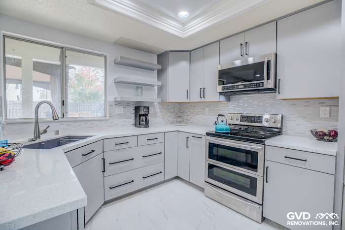 Modern Sacramento kitchen remodel featuring gray cabinetry, stainless steel appliances, and a light quartz countertop