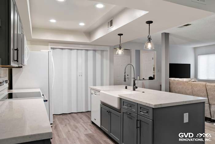 Modern kitchen remodel featuring gray cabinets, quartz island, and pendant lighting in Sacramento home