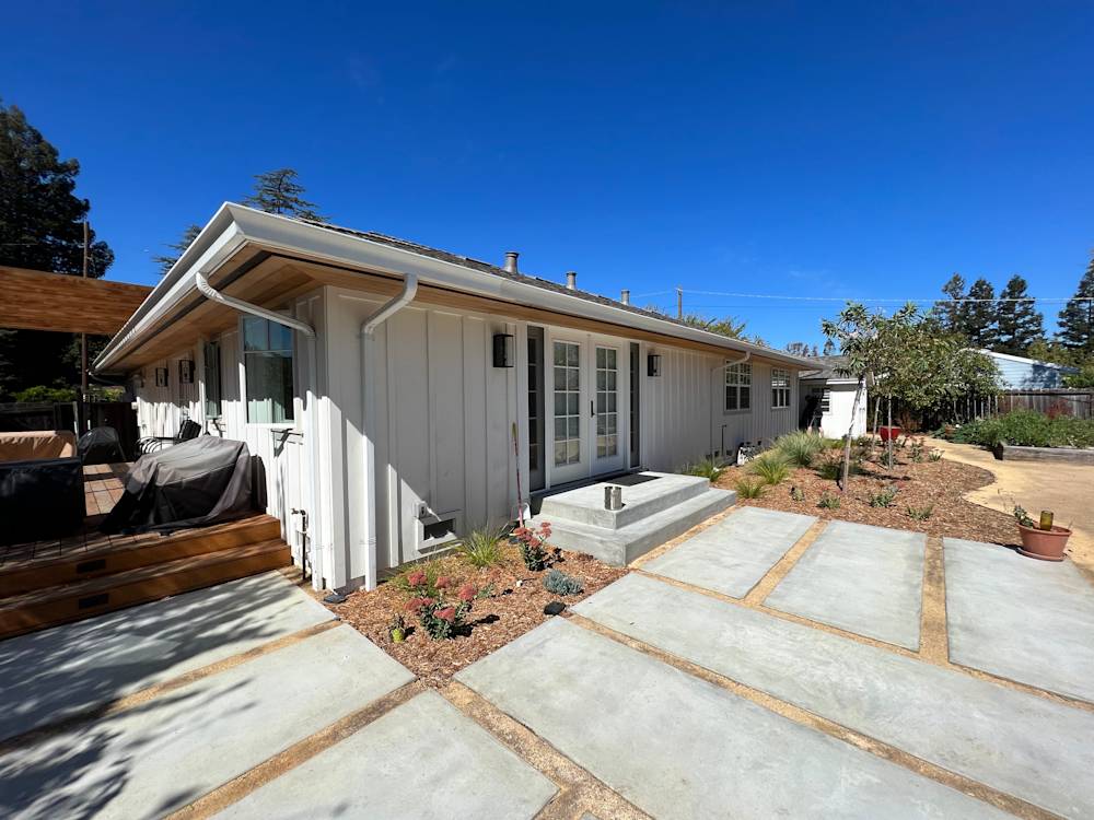 Concrete patio with stepping stones, surrounded by landscaped garden in Sacramento