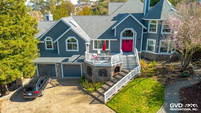 Exterior of a Petaluma home featuring Night Gray James Hardie siding and Arctic White trim with a red front door