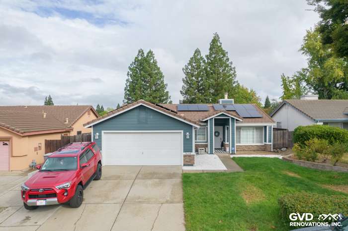 Home exterior in Rocklin, CA featuring James Hardie Evening Blue siding, Arctic White trim, and Eldorado Stone accents
