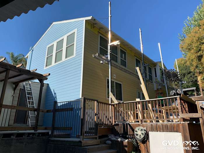 Renovated Oakland home exterior featuring James Hardie fiber cement siding in light blue and new vinyl windows